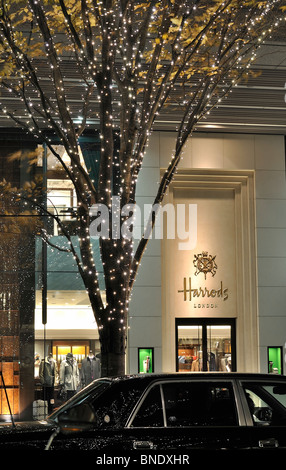 Night shot of 'Harrods' department store in Tokyo`s financial district ('Marunouchi') with Christmas illuminated tree (Japan) Stock Photo